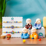 Load image into Gallery viewer, Webelkart Antique Evil Eye Designer Set of 3 Rakhi for Brother Bhabhi with Gift -Set of 4 Miniature Buddha Monk Figurines Showpiece For Car dashboard ,Rakhi Gift for Bhaiya and Bhabhi With Chawal And Greeting Card