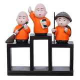 Load image into Gallery viewer, Webelkart Premium Set of 3 Child Monk Showpiece for Home and Office Decor| Child Monk Showpiece for Gift| Showpiece for Car Dashboard (Polyresin,Orange)